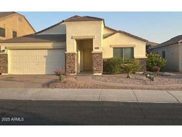 Charming single-story home with a two car garage and stone accents near the entry at 12041 W Carlota Ln, Sun City, AZ 85373
