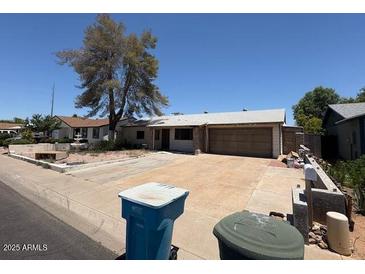 Single level home with desert landscaping and a two car garage at 18415 N 33Rd Ave, Phoenix, AZ 85053