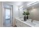 Modern bathroom with double vanity, framed mirror, and a view of the bedroom at 3131 N Central Ave # 6011, Phoenix, AZ 85012
