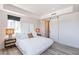 Bright bedroom with large windows offering city views, barn-door closet, and modern lighting at 3131 N Central Ave # 6011, Phoenix, AZ 85012