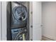 Modern laundry area with gray stacked washer and dryer units and white door at 3131 N Central Ave # 6011, Phoenix, AZ 85012