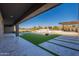 Artificial turf backyard with a large pool and patio at 8366 E Old Paint Trl, Scottsdale, AZ 85266