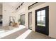 Light-filled entryway with stylish black door and natural light at 8366 E Old Paint Trl, Scottsdale, AZ 85266