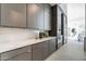 Modern kitchen with gray cabinets and marble countertops at 8366 E Old Paint Trl, Scottsdale, AZ 85266