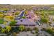 Aerial view of homes with desert landscaping, a pool, and golf course in the background at 12797 S 179Th Dr, Goodyear, AZ 85338