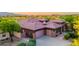 Aerial shot showcasing the home's tile roof, desert landscaping, and three car garage at 12797 S 179Th Dr, Goodyear, AZ 85338