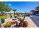 Inviting backyard featuring a fire pit, lush plants, and outdoor seating, perfect for entertaining at 12797 S 179Th Dr, Goodyear, AZ 85338