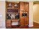 Custom home bar area featuring wine racks, wine glass storage, and built-in coffee maker at 12797 S 179Th Dr, Goodyear, AZ 85338