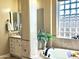 Bright bathroom featuring a soaking tub, vanity, and glass block window providing natural light at 12797 S 179Th Dr, Goodyear, AZ 85338