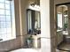 Elegant bathroom with a glass block window, spacious vanity, and stylish decor at 12797 S 179Th Dr, Goodyear, AZ 85338