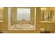 Relaxing bathroom featuring a soaking tub, dual vanities, and decorative tile accents at 12797 S 179Th Dr, Goodyear, AZ 85338