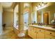 Bright bathroom featuring a double sink vanity, tiled floors and walls, and a large garden tub at 12797 S 179Th Dr, Goodyear, AZ 85338