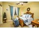 Comfortable bedroom features a wood-framed bed and soft, colorful bedding at 12797 S 179Th Dr, Goodyear, AZ 85338