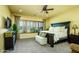 Inviting bedroom with large bed, plantation shutters, and a ceiling fan at 12797 S 179Th Dr, Goodyear, AZ 85338