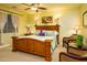 Bedroom with hardwood furniture, ceiling fan, carpeted floors, and natural light from windows at 12797 S 179Th Dr, Goodyear, AZ 85338