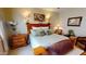 Cozy bedroom features a wooden headboard with sconces, soft pillows, and bedside table at 12797 S 179Th Dr, Goodyear, AZ 85338