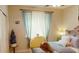 Cozy bedroom featuring soft, sheer curtains, a decorative window seat and inviting bedding for a relaxed atmosphere at 12797 S 179Th Dr, Goodyear, AZ 85338