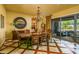 Dining room featuring an elegant chandelier and an adjacent outdoor living area perfect for entertaining at 12797 S 179Th Dr, Goodyear, AZ 85338