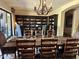 Well-appointed dining area features a solid wood table, decorative lighting, and built-in bookcase, perfect for Gathering gatherings at 12797 S 179Th Dr, Goodyear, AZ 85338