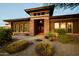 Inviting home exterior with stone accents, desert landscaping, and warm lighting create curb appeal at 12797 S 179Th Dr, Goodyear, AZ 85338