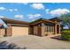 Beautiful single-Gathering home featuring a three-car garage, stone accents, and a well-maintained front yard at 12797 S 179Th Dr, Goodyear, AZ 85338