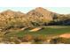 Picturesque golf course with sand traps, lush green fairways, and desert mountain views at 12797 S 179Th Dr, Goodyear, AZ 85338