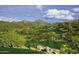 Picturesque golf course surrounded by lush greenery, mountains, and blue skies with clouds at 12797 S 179Th Dr, Goodyear, AZ 85338