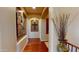 Inviting hallway with hardwood floors and decorative wall art, leading to other parts of the home at 12797 S 179Th Dr, Goodyear, AZ 85338