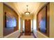 Grand entry hallway with hardwood floors, archways, elegant lighting, and an impressive wood front door at 12797 S 179Th Dr, Goodyear, AZ 85338
