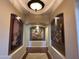Elegant hallway featuring recessed lighting, neutral paint, archways, and beautiful artwork, creating a welcoming transition between spaces at 12797 S 179Th Dr, Goodyear, AZ 85338