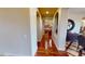 Hallway with hardwood floors and arches leading to kitchen, showcasing the home's open layout at 12797 S 179Th Dr, Goodyear, AZ 85338