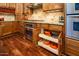 Chef's kitchen features stainless steel appliances, granite countertops, and custom cabinet organizers at 12797 S 179Th Dr, Goodyear, AZ 85338