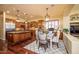 Open-concept kitchen featuring a center island, stainless appliances, and an adjacent dining area at 12797 S 179Th Dr, Goodyear, AZ 85338