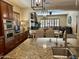 Well-equipped kitchen with granite countertops, stainless steel appliances, and an open layout connecting to the dining and living areas at 12797 S 179Th Dr, Goodyear, AZ 85338