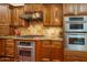 Well-equipped kitchen featuring stainless steel appliances, custom cabinets, and granite countertops at 12797 S 179Th Dr, Goodyear, AZ 85338