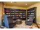 Cozy library with custom built-in bookshelves and comfortable seating perfect for reading and relaxing at 12797 S 179Th Dr, Goodyear, AZ 85338
