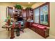 Comfortable office space with custom wooden cabinets and a workstation with a computer at 12797 S 179Th Dr, Goodyear, AZ 85338