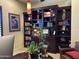 Home office featuring custom built-ins, shelving, and ample storage space at 12797 S 179Th Dr, Goodyear, AZ 85338