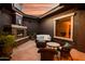 Inviting outdoor patio with a cozy fireplace and comfortable seating area, perfect for relaxing or entertaining guests at 12797 S 179Th Dr, Goodyear, AZ 85338