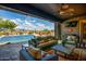Inviting covered patio with comfortable seating and scenic pool and desert views at 12797 S 179Th Dr, Goodyear, AZ 85338