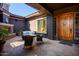 Charming covered patio with a fireplace and stylish furniture, creating an inviting outdoor living space at 12797 S 179Th Dr, Goodyear, AZ 85338