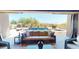Inviting patio features comfortable seating overlooking a pool with fountains and desert landscape at 12797 S 179Th Dr, Goodyear, AZ 85338
