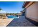 Backyard pool and patio area boasts a travertine deck and easy access to outdoor entertainment spaces at 12797 S 179Th Dr, Goodyear, AZ 85338