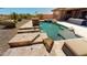 Inviting backyard pool and spa with stone accents and a lounge area for ultimate relaxation at 12797 S 179Th Dr, Goodyear, AZ 85338