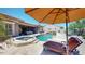 Beautiful backyard with a pool, spa, lounge chair, and umbrella, perfect for outdoor enjoyment at 12797 S 179Th Dr, Goodyear, AZ 85338