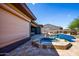 Inviting backyard features a sparkling pool, spa, and travertine deck, ideal for outdoor living at 12797 S 179Th Dr, Goodyear, AZ 85338