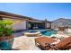 Lounge by the pool in this backyard oasis, complete with a spa and travertine deck at 12797 S 179Th Dr, Goodyear, AZ 85338
