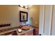 Elegant powder room features a vessel sink, granite countertop, and sophisticated decor, creating a refined and inviting space at 12797 S 179Th Dr, Goodyear, AZ 85338