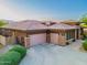 Rear exterior featuring three garage doors and desert landscaping at 12797 S 179Th Dr, Goodyear, AZ 85338