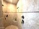 Contemporary shower with tiled walls, multiple shower heads, and built-in shelves at 12797 S 179Th Dr, Goodyear, AZ 85338